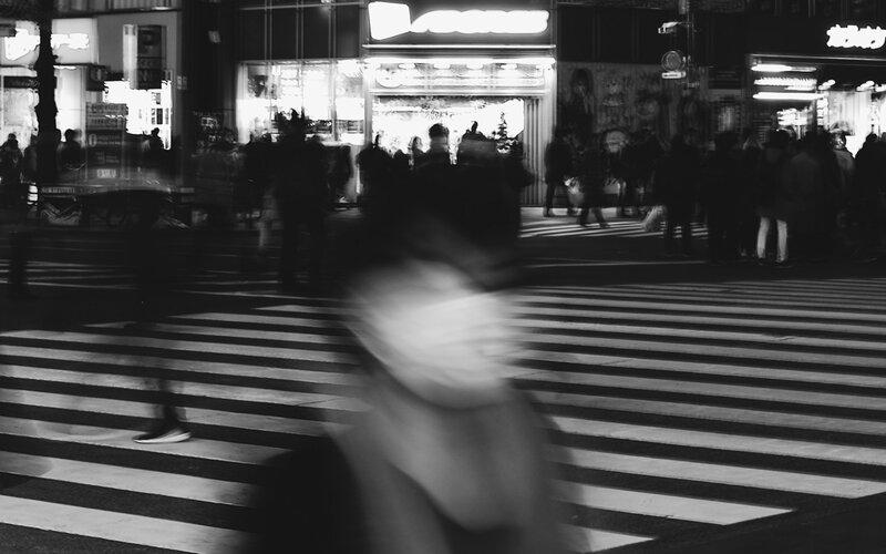 A blurred figure on the street