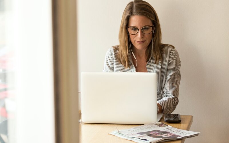 A person typing on their laptop