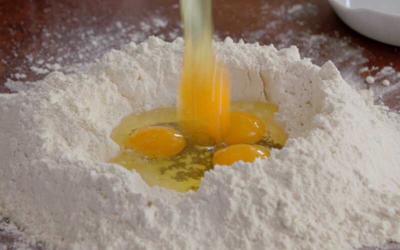 a well of flour with eggs inside